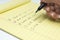 Closeup Of Female\'s Hand Writing List Of Tasks To Do