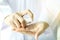 Closeup of female scientist hands testing texture of beauty products.