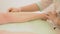 Closeup of female therapist waxing customer\'s leg at beauty spa. depilation legs