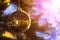 Closeup of Festively Decorated Outdoor Christmas tree with bright gold ball on blurred sparkling fairy background. Defocused