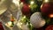 Closeup of festively decorated outdoor Christmas tree with bright red balls on blurred sparkling fairy background