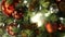 Closeup of Festively Decorated Outdoor Christmas tree with bright red balls on blurred sparkling fairy background