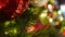 Closeup of Festively Decorated Outdoor Christmas tree with bright red balls on blurred sparkling fairy background