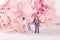 Closeup of  figurines of a happy family standing on a calendar on a floral background