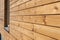 Closeup of finally slatted natural wood on house.