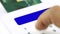 Closeup finger entering pin personal identification number for electronic purchasing by credit or debit card blue screen display