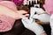 Closeup finger nail care by pedicure specialist in beauty salon.