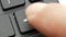 Closeup finger pressing enter key on computer keyboard