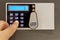 Closeup finger touching keypad of digital safe