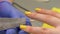 Closeup of fingernail shape correction using nail file. Yellow polish. Last manicure strokes. Beauty salon.