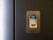 Closeup fingerprint sensor on modern armored metallic black door and blue light led indicator