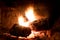 Closeup of firewood burning in fire with long exposure and flames like glowing light. Concept of tranquility, relaxation and