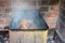 Closeup of fish pike smoke in smokehouse made of old traditional russian siberian dish