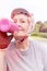 Closeup of fit senior woman drinking water while cycling in park