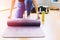 Closeup fitness woman in sport club studio with yoga mat. Young woman roll pilates mat at a fitness training class