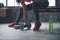 Closeup on fitness woman taking dumbbell from the floor in gym