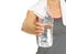 Closeup on fitness young woman giving bottle of water