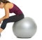 Closeup on fitness young woman sitting on fitness ball