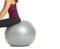 Closeup on fitness young woman sitting on fitness ball