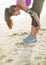 Closeup on fitness young woman stretching on beach
