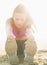 Closeup on fitness young woman stretching on beach