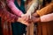 Closeup of five arms joining hands in a feminist movement hands of a group of multicultural women