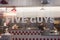 Closeup of five guys sign on fast food restaurant facade in the street