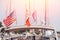 Closeup flags of France and United States on white yacht with light of sun