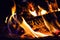 Closeup of the flames of a campfire with a blurry background during the night