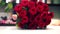 Closeup florist collects a large and luxurious bouquet of red roses.