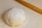 Closeup floured dough for tasty bakery on light table background
