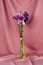 Closeup of a flower bouquet standing  a table covered with pink cloth