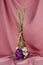 Closeup of a flower bouquet standing upside down on a table covered with pink cloth