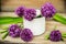 Closeup of flowering chives with shallow depth of field and focus concentrated on flower in the foreground