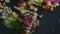 Closeup focus in at fried meat pieces with potato chips and vegetable salad on black