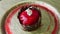 Closeup focus out from trendy red glazed dessert with chocolate castle on golden plate