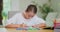 Closeup focused teen girl, at the desk, draws with brown felt -tip pens on white paper sheet Felt-tip pens, tablet