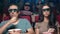 Closeup focused unbelievable Hispanic couple watching interesting film in 3D glasses eating popcorn