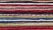 Closeup of folded rugs texture. Striped pattern background