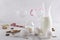 Closeup of food product for preparing eggnog drink.Milk, eggs, sugar, spices, glasses for drinks, Christmas candy canes against wh