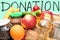 Closeup of foodstuffs in donation box on neo mint background. Charitable donation for people in need. Assistance concept