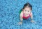 Closeup foot of little child girl wear mermaid swimming suit lying in the pool