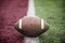 Closeup of a football sitting on the goal line at a football Stadium