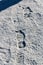 Closeup of footsteps in snow going forward. Exploring, adventure, journey concept