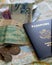 closeup of foreign coins, paper currency and two American passports laying on large open map