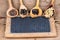 Closeup of four wooden cooking spoons with various exotic spices and an old slate blackboard