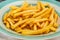 Closeup of frech fries on ceramic dish