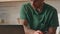 Closeup freelancer hands texting keyboard taking coffee at kitchen. Man drinking