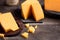 Closeup of fresh cheddar cheeses on a wooden table