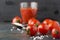 Closeup of fresh cherry tomatoes and salt on dark table.Preparing homemade tomato juice.